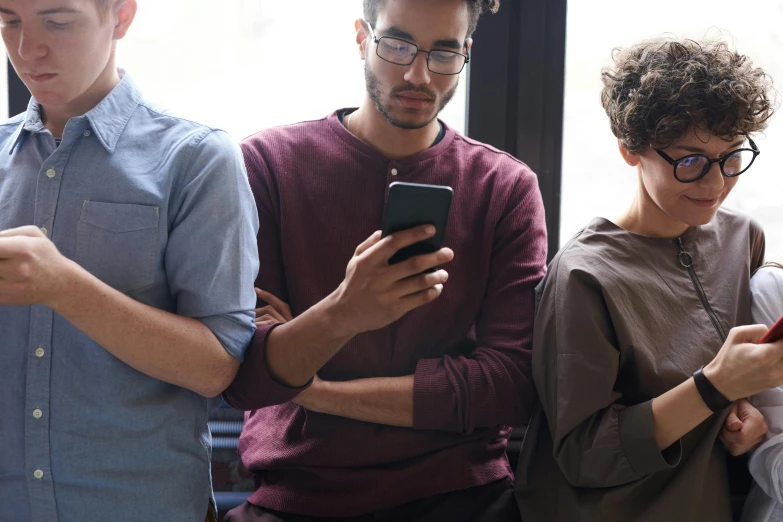 a man is standing next to another man on his phone