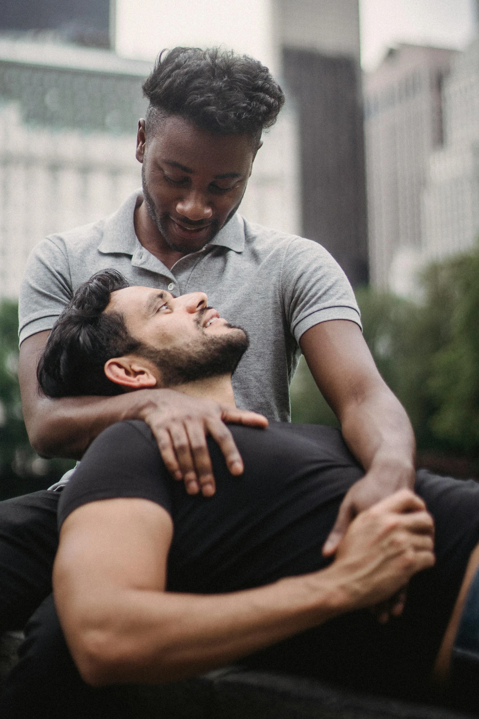 man giving another man a hug while outside