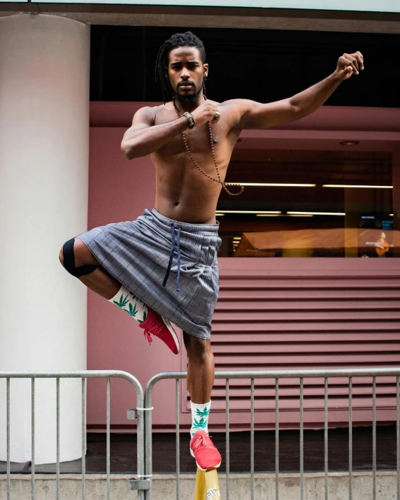 an african american man is performing a kick