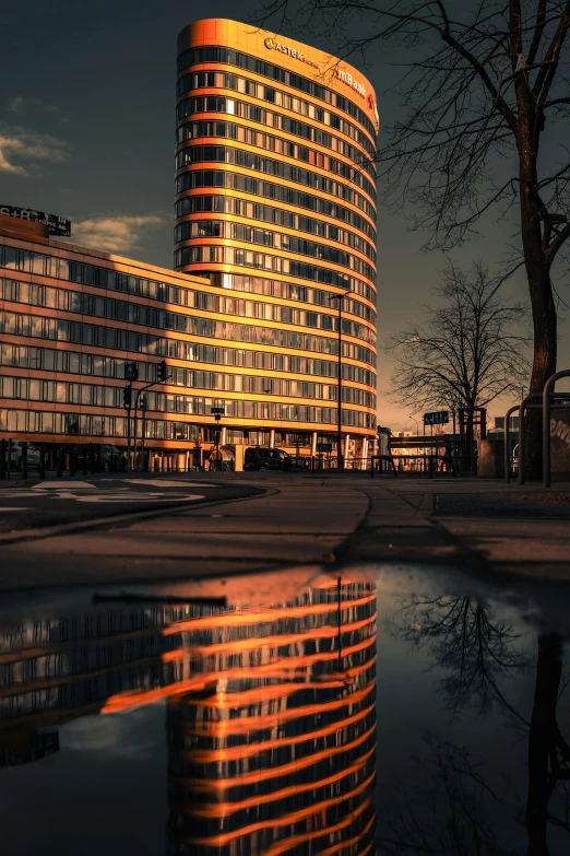 a building that has reflective water on the ground