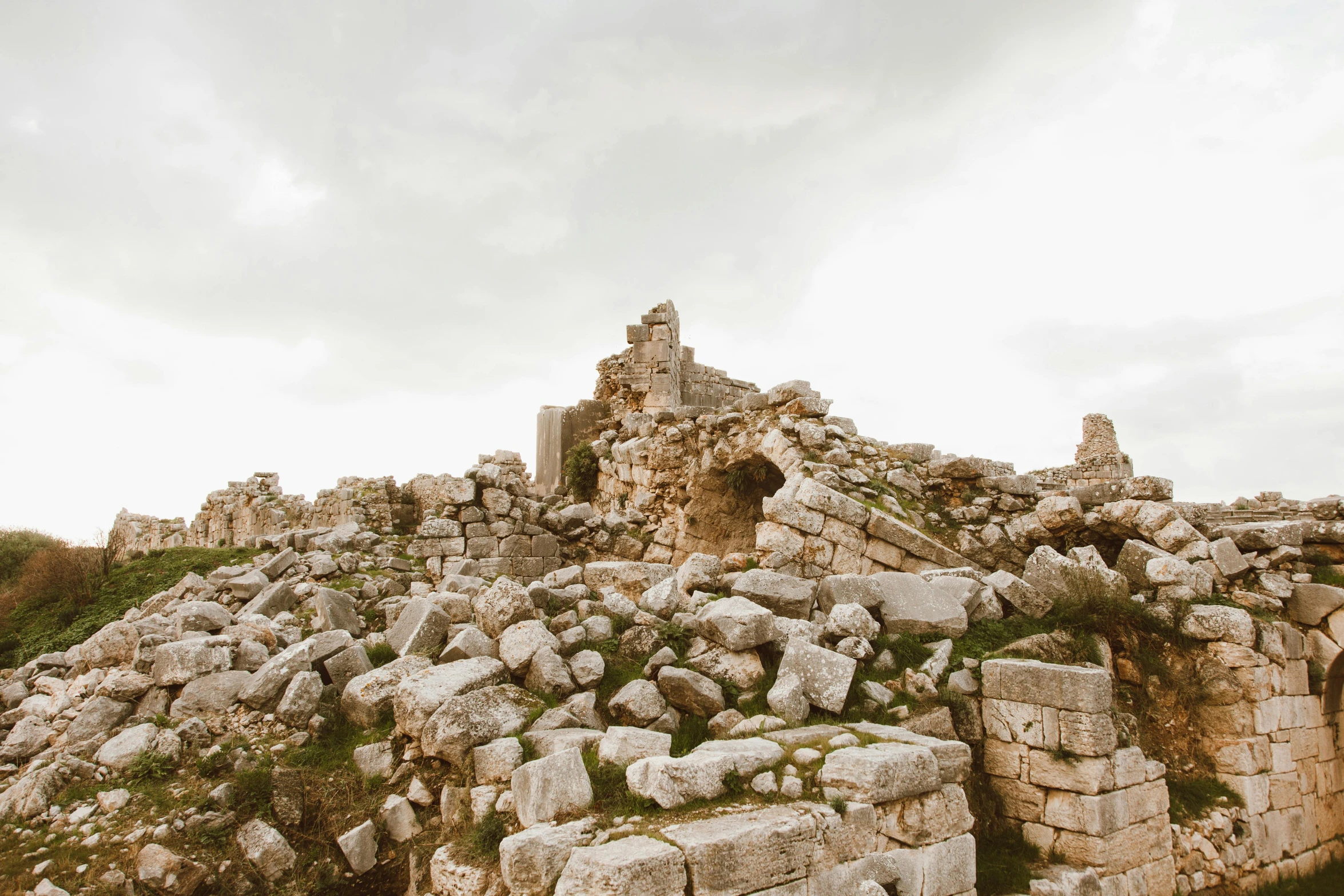 a rock wall with a building on top