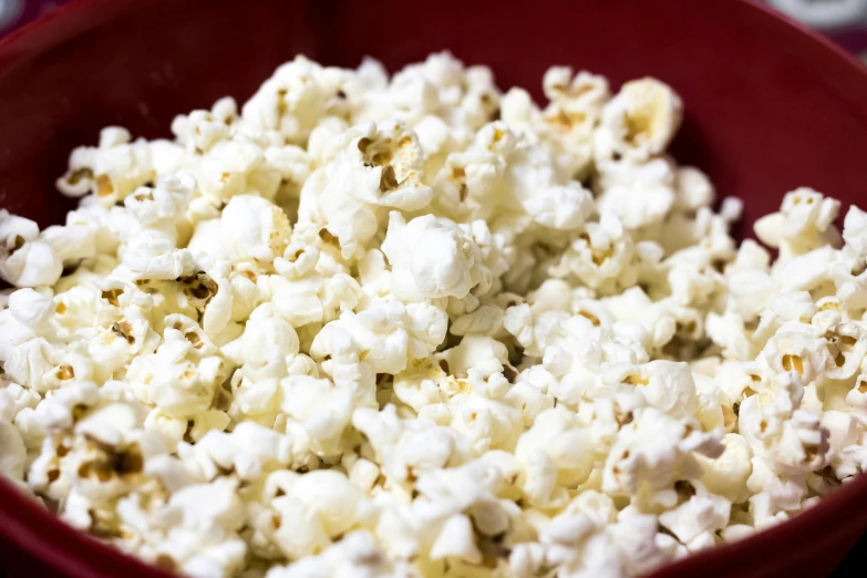 a red bowl filled with white popcorn