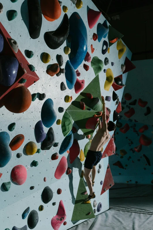 a man that is climbing on a big wall