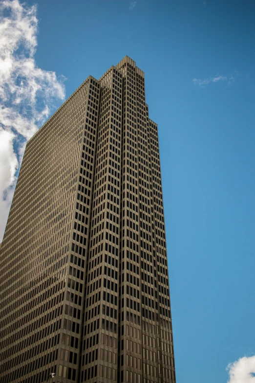 a large grey building sits on a clear day