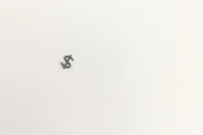 a dollar sign on top of a table near a laptop