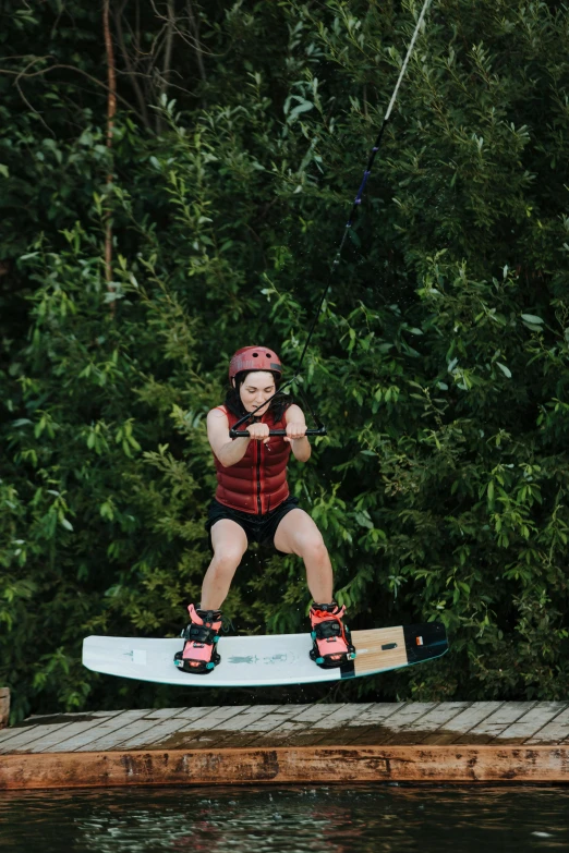 there is a woman that is on top of a surfboard