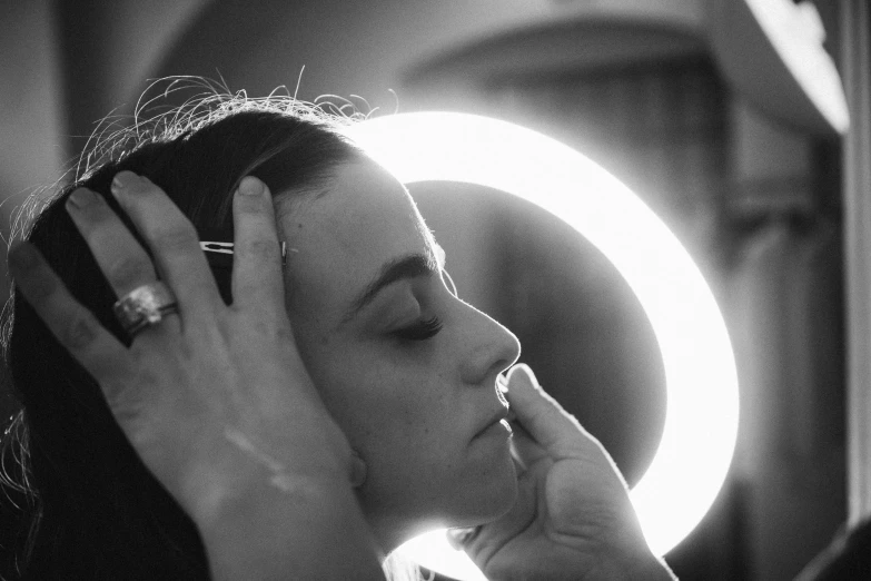 a woman talking on her cell phone while holding her head