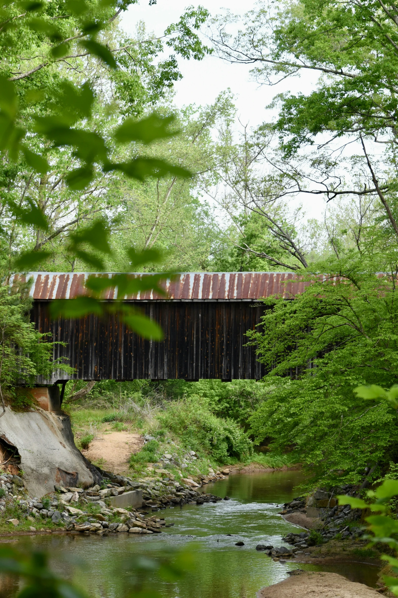 a rustic wooden bridge over a small creek