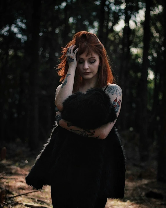 a woman wearing an outfit standing in the woods