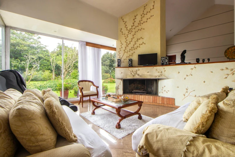 a living room with windows, couches, tables and television