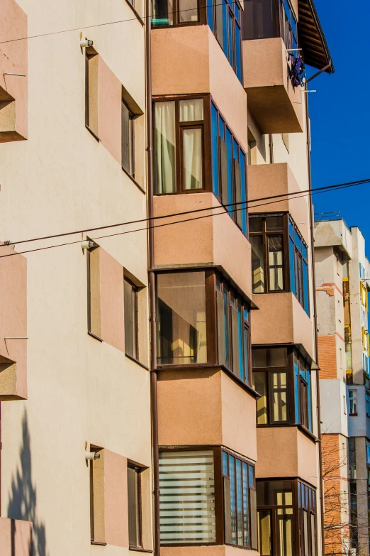 an apartment building in front of a blue sky