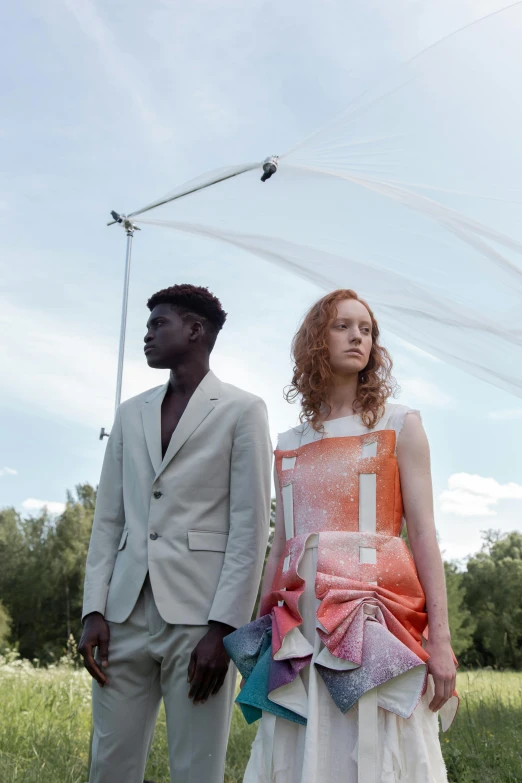 the young man and the beautiful woman stand near each other