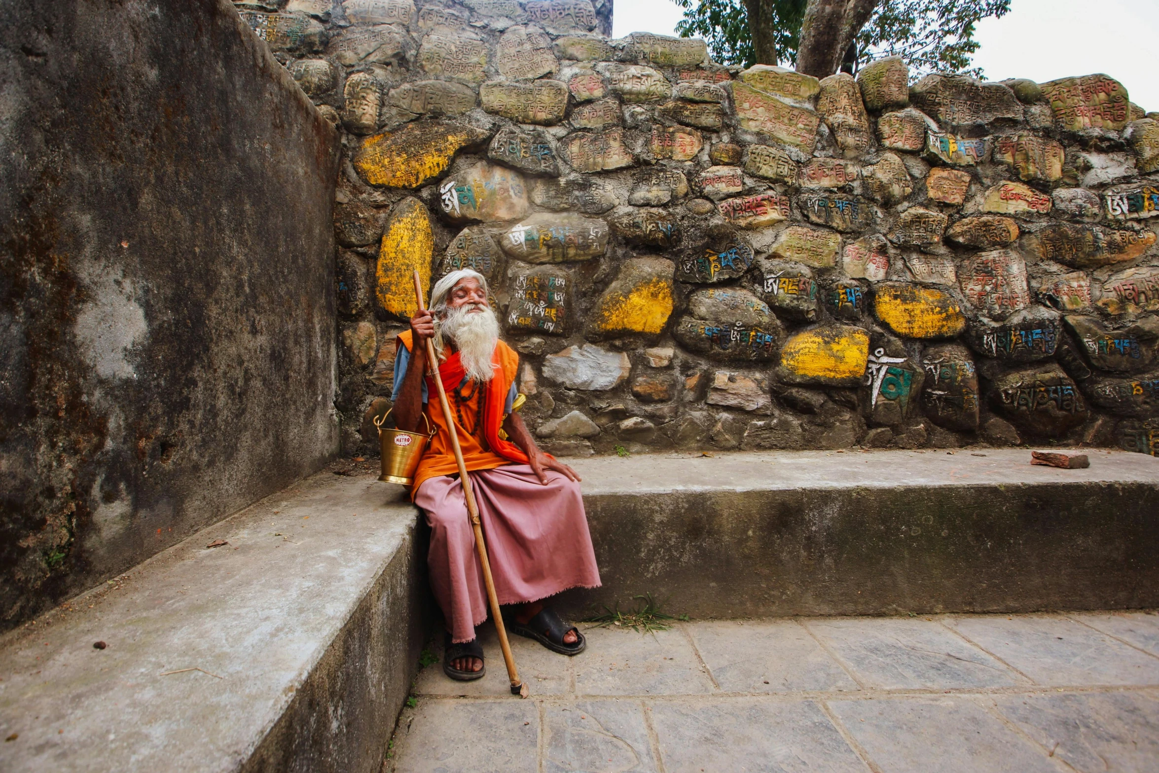 a man dressed in an orange suit sitting on steps