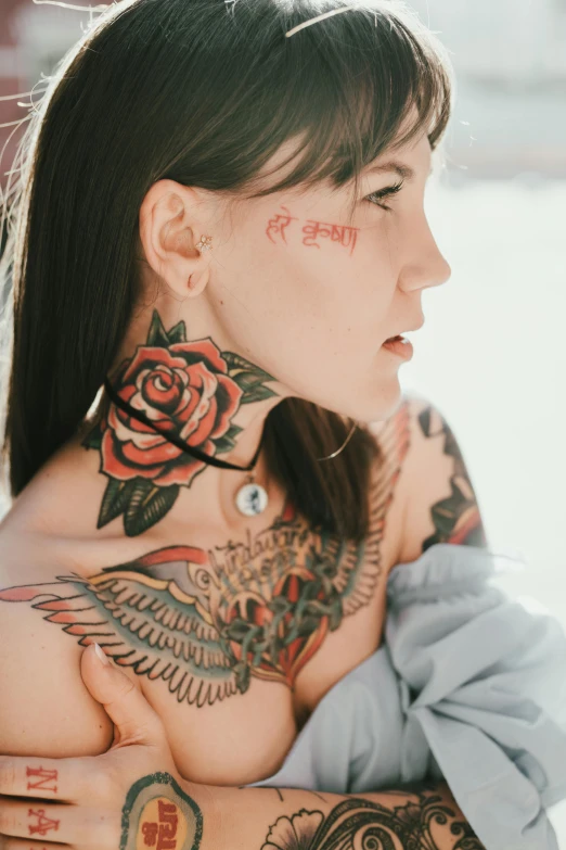 woman with arm tattoo in front of tree