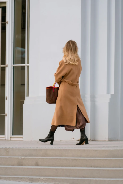 a woman is walking down a stair case