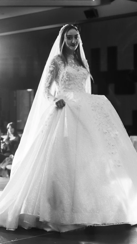 black and white pograph of a bride in the front of a room