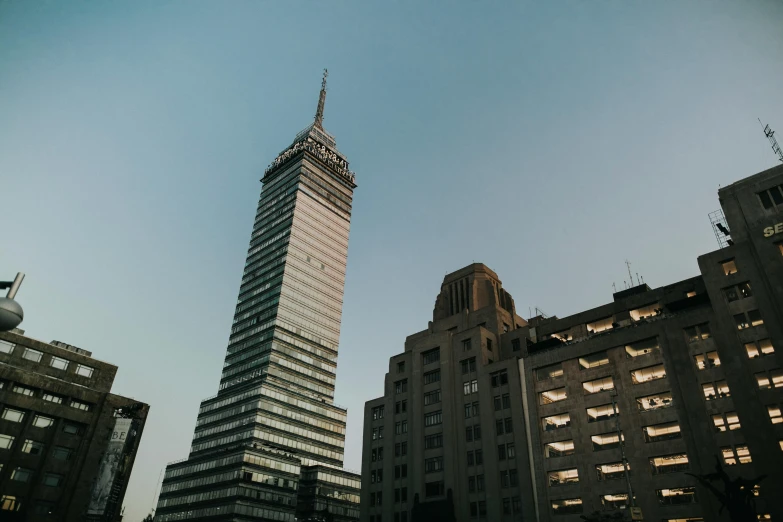 a very tall building in the middle of some other buildings