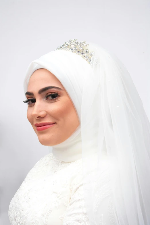 a woman in a veil and veille smiles at the camera