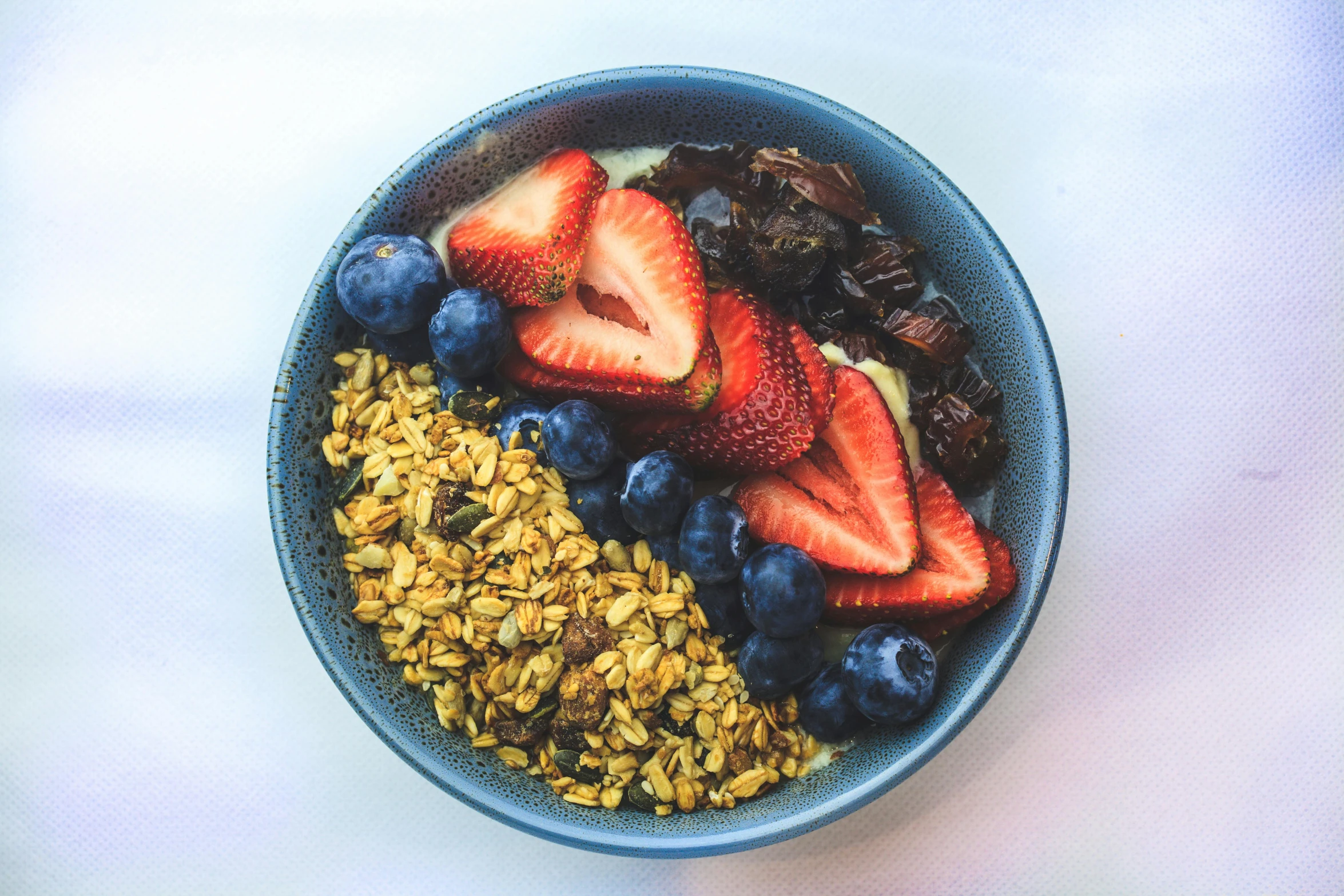 a bowl full of fruit and cereal is shown