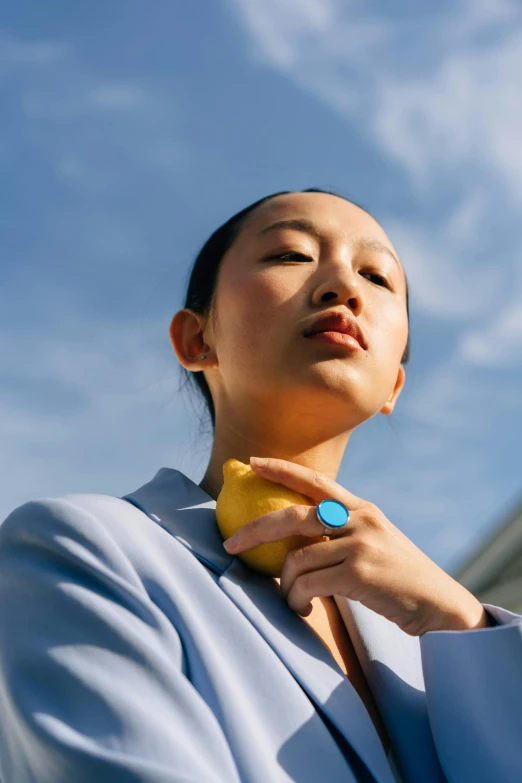 a woman wearing a blue jacket is looking up