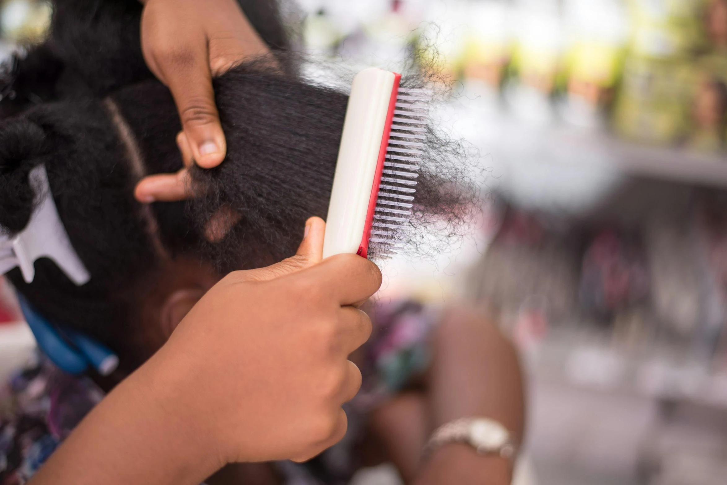 woman is brushing her long hair with a brush