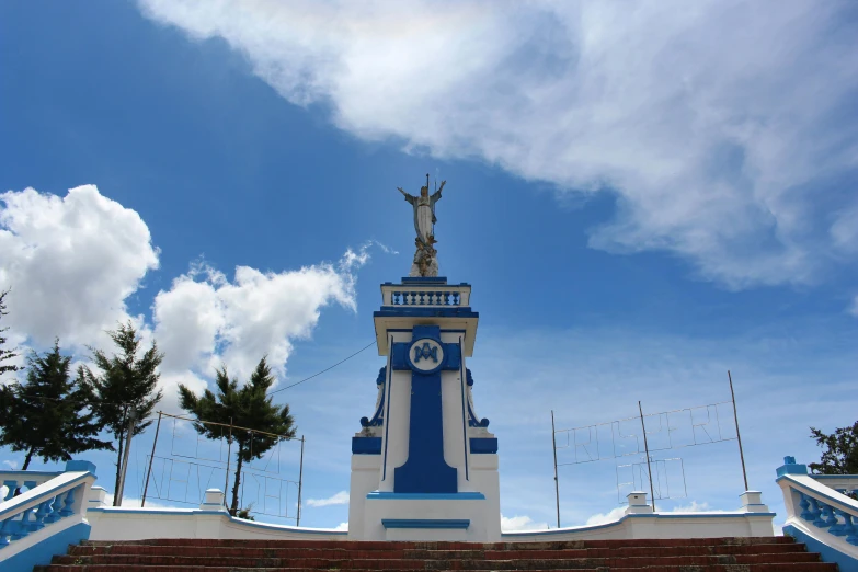 a large white and blue clock tower sitting under a blue sky