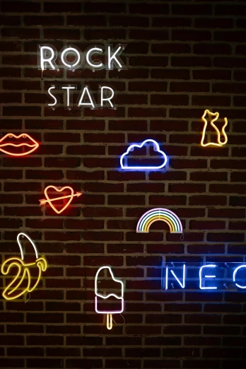 the logo of rock star lit up against a brick wall