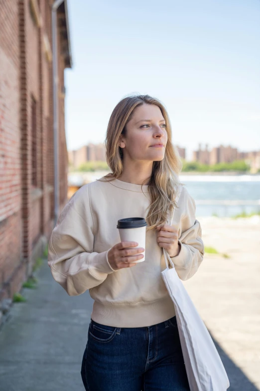 a woman with a bag and a coffee drink