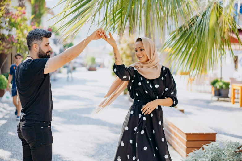 a man and woman dancing in the street together