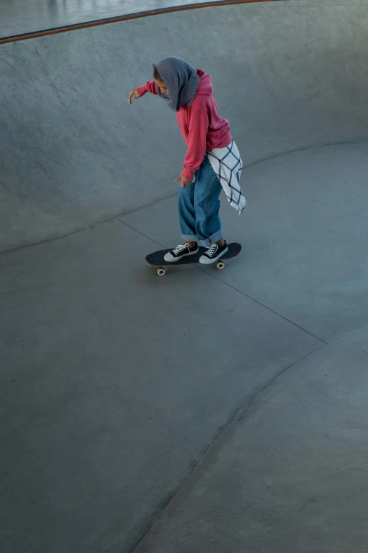 a young child is practicing skating on a skateboard