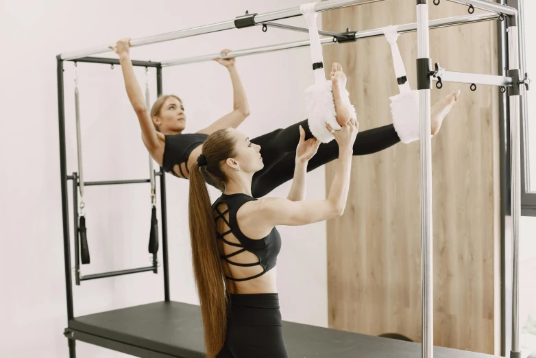 two girls holding their hands in the air doing exercises