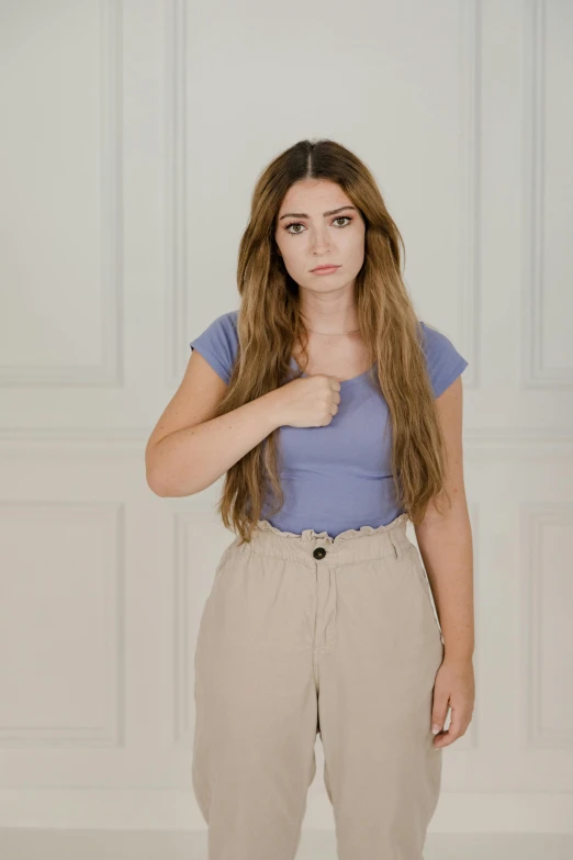 the young woman with a blue shirt and tan pants