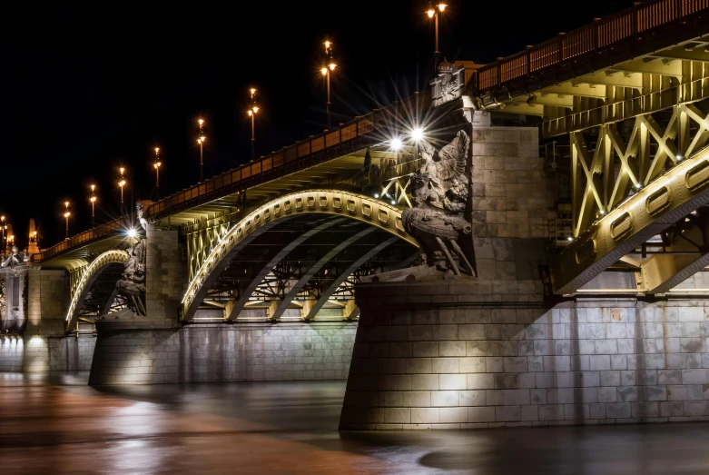 a view of the bridge at night from the shore