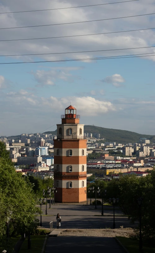 a large tall tower sitting above a city