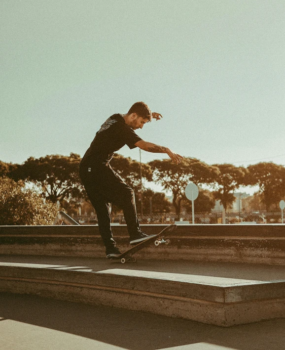 man on a skateboard balancing it on a ramp