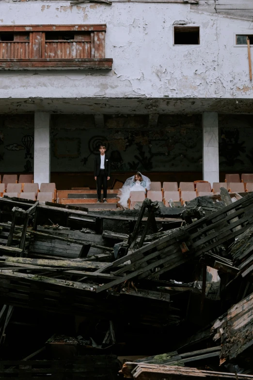 the bride and groom are posing in front of some dilapidated buildings