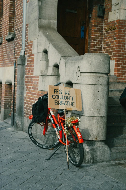 a bicycle parked next to a red brick building