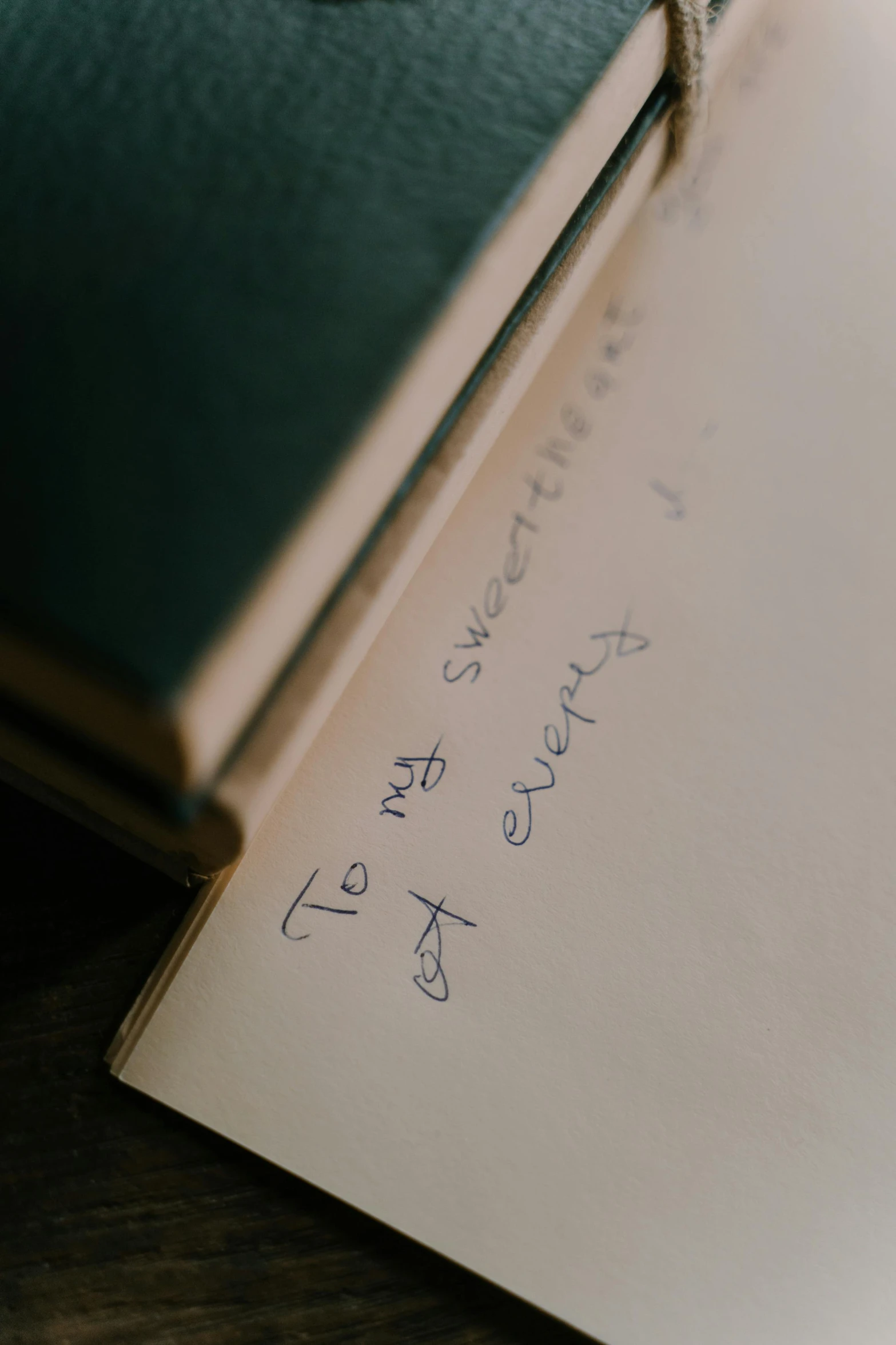 an open book on a table with handwriting