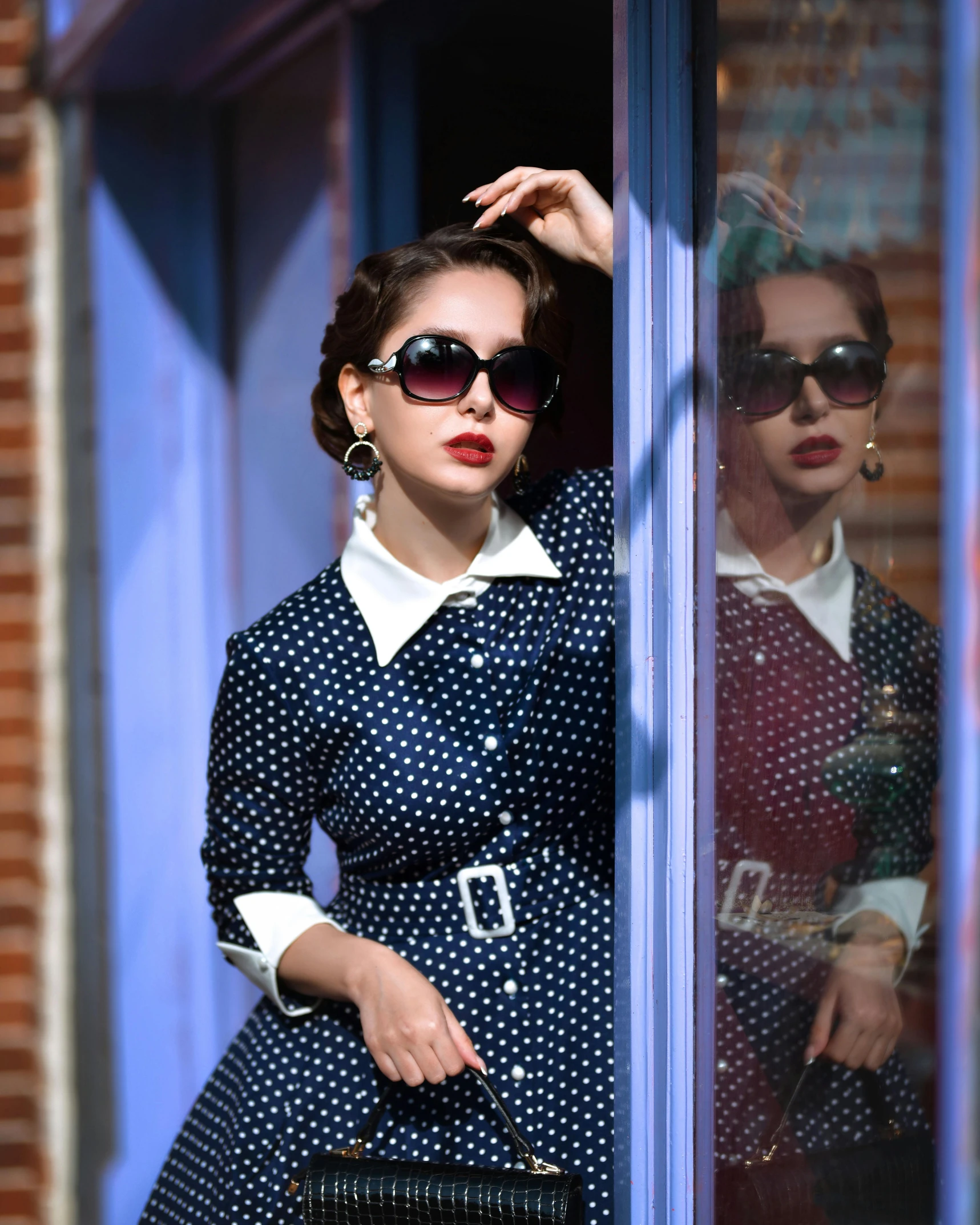 a woman wearing sunglasses and a polka dot dress