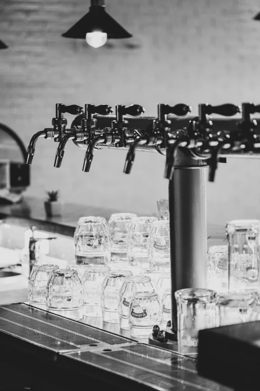 a row of wine glasses sitting on a bar