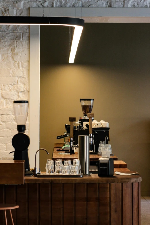 coffee machines on a counter with one coffeemaker being used