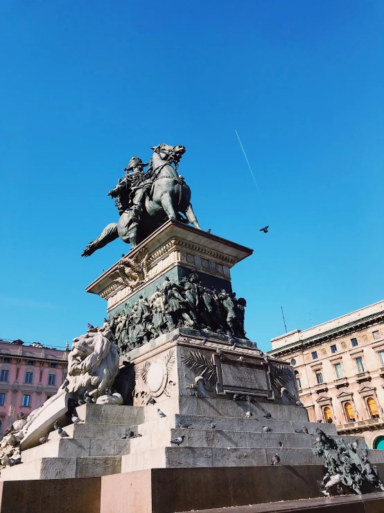 statue with a jet plane passing in background and blue sky