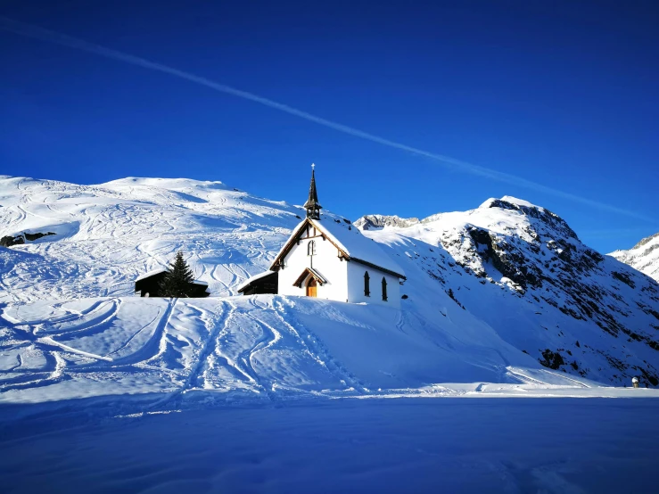 a house on top of a snow covered mountain