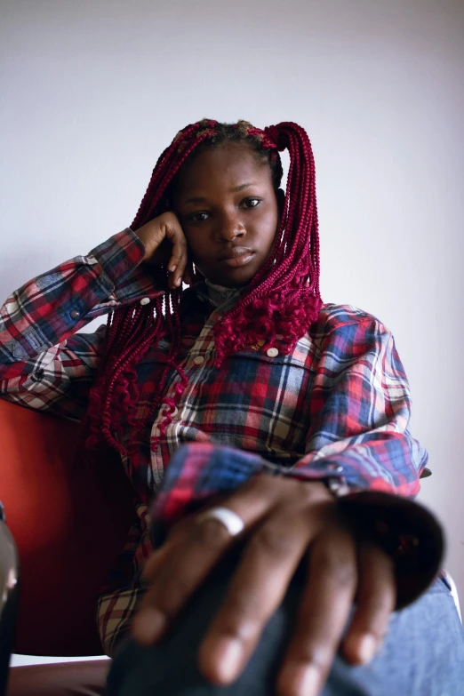 woman sitting in chair with head scarf on her hair