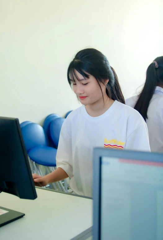 two s looking at computers at a school