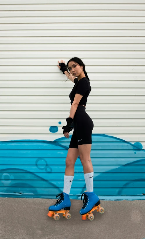 a woman in black shirt and shorts skateboarding