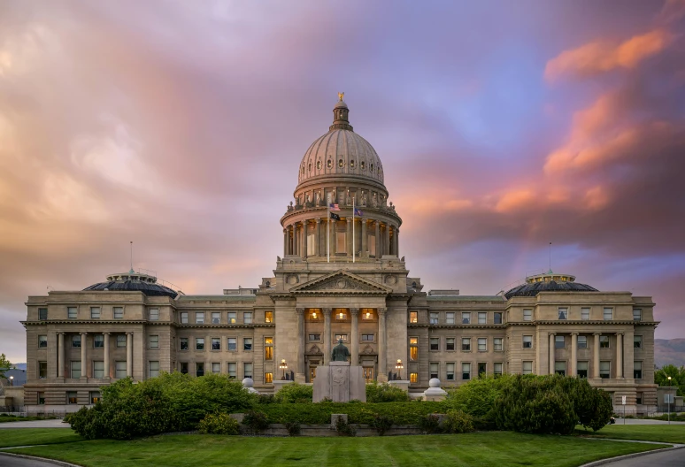 a large building with two turrets at sunset