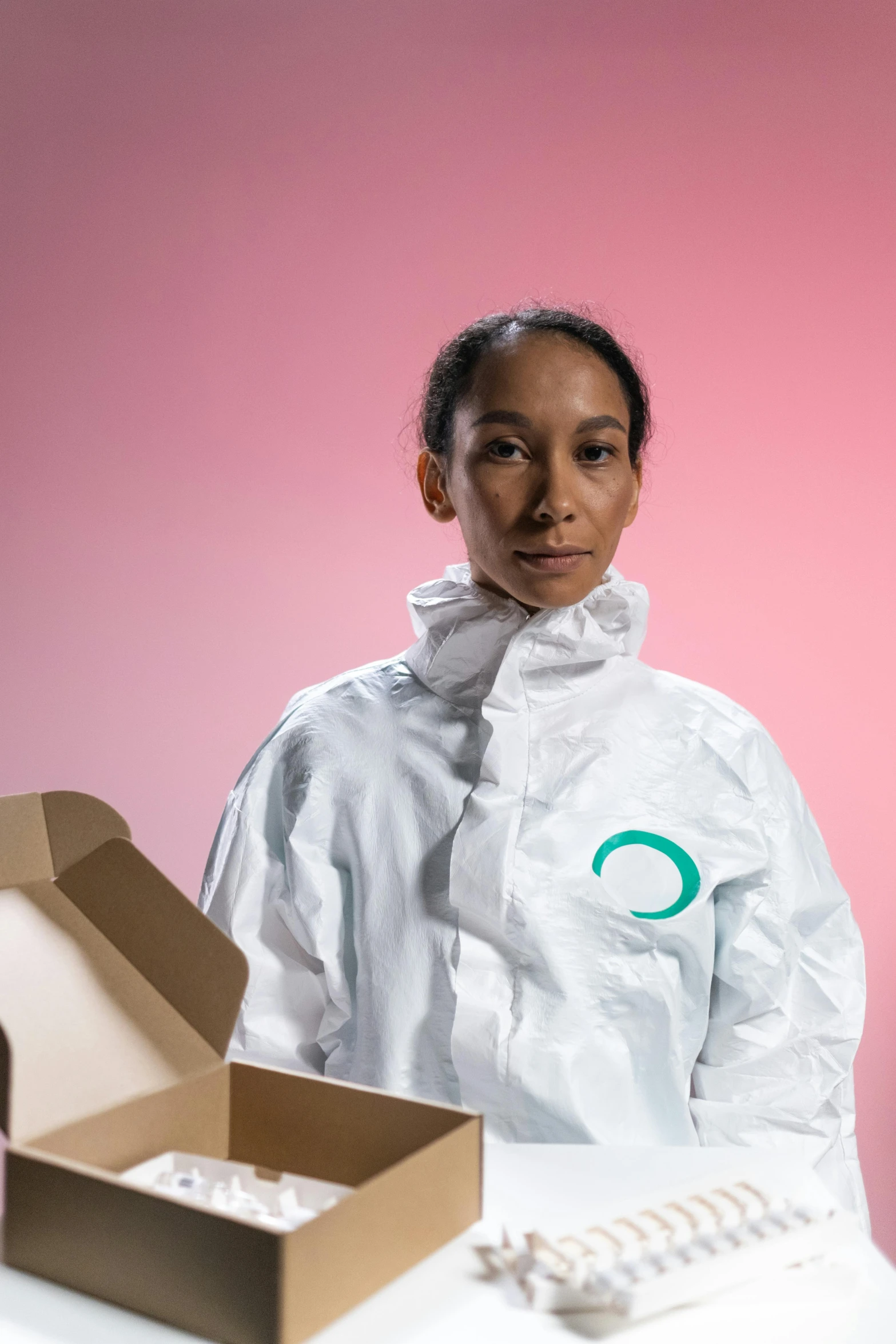 a person standing in front of a box with pills