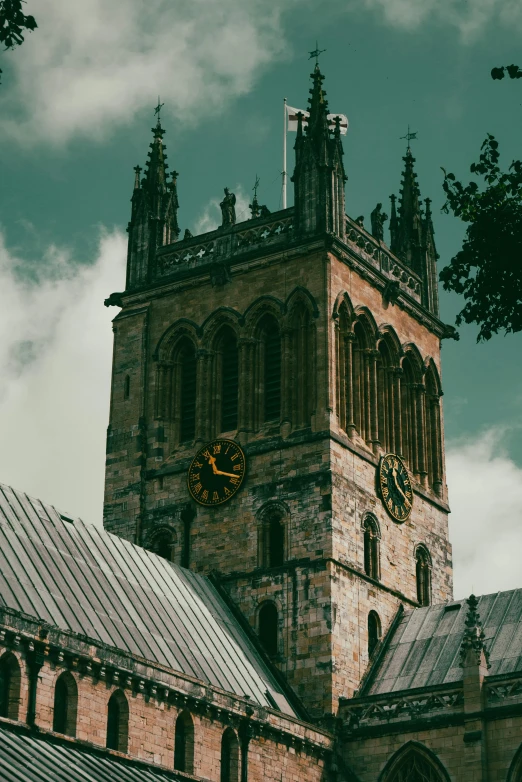 two clocks are at the top of a tall tower