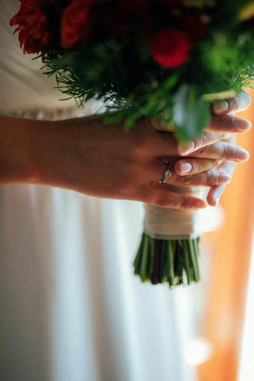 two brides hold on to each other's bouquet